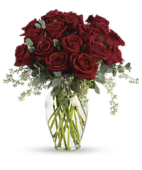 30 Red roses and eucalyptus in a clear glass vase. 
