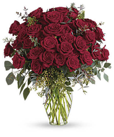 30 Red roses and eucalyptus in a clear glass vase. 