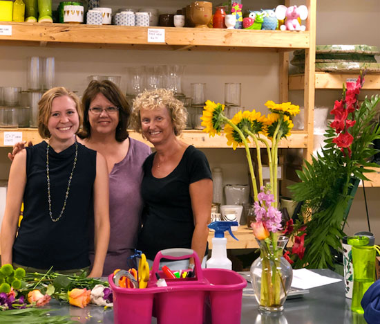 Three Julia's staff members composing an arrangement